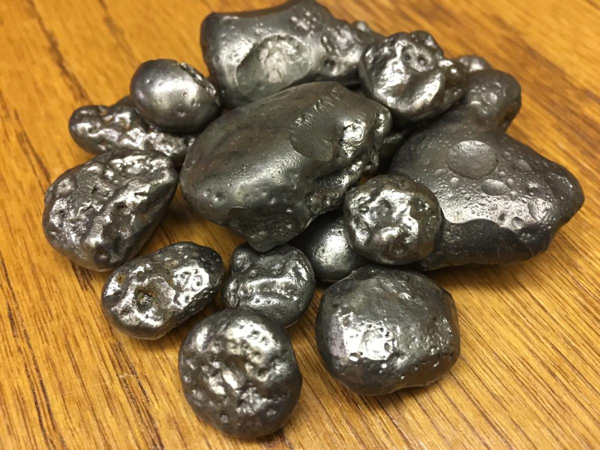 A small pile of a dozen pieces of iron nuggets of varying sizes.