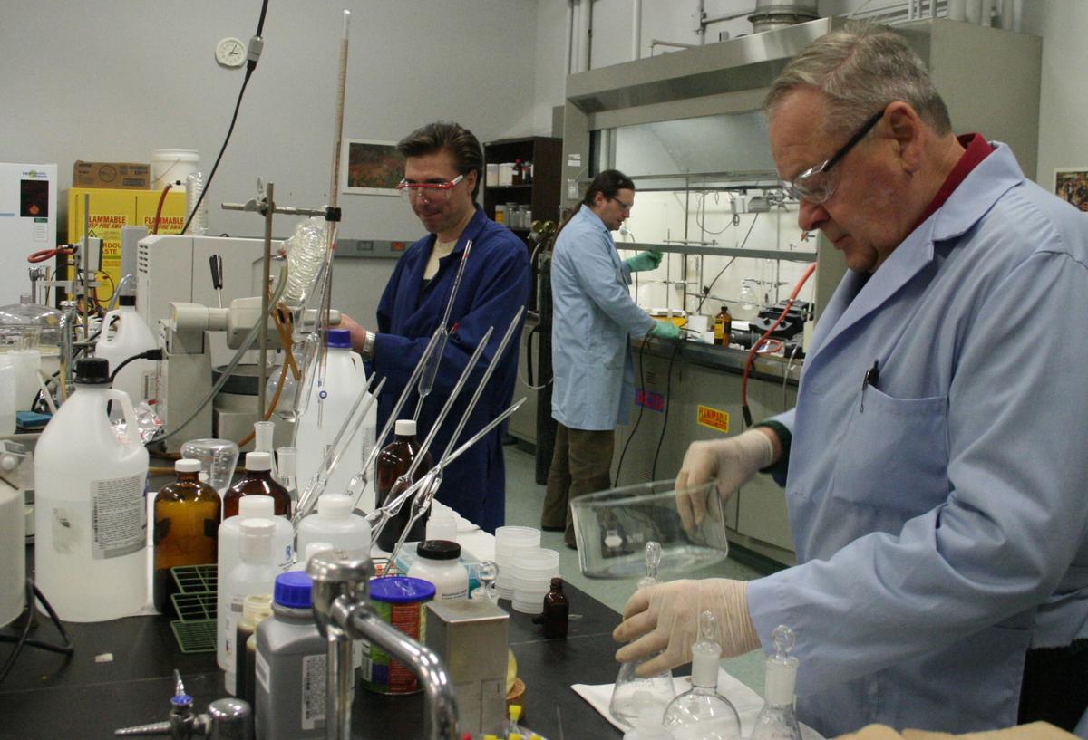 Man in blue lab coat in chemistry lab