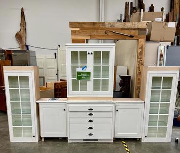Cabinets propped in warehouse for resale.